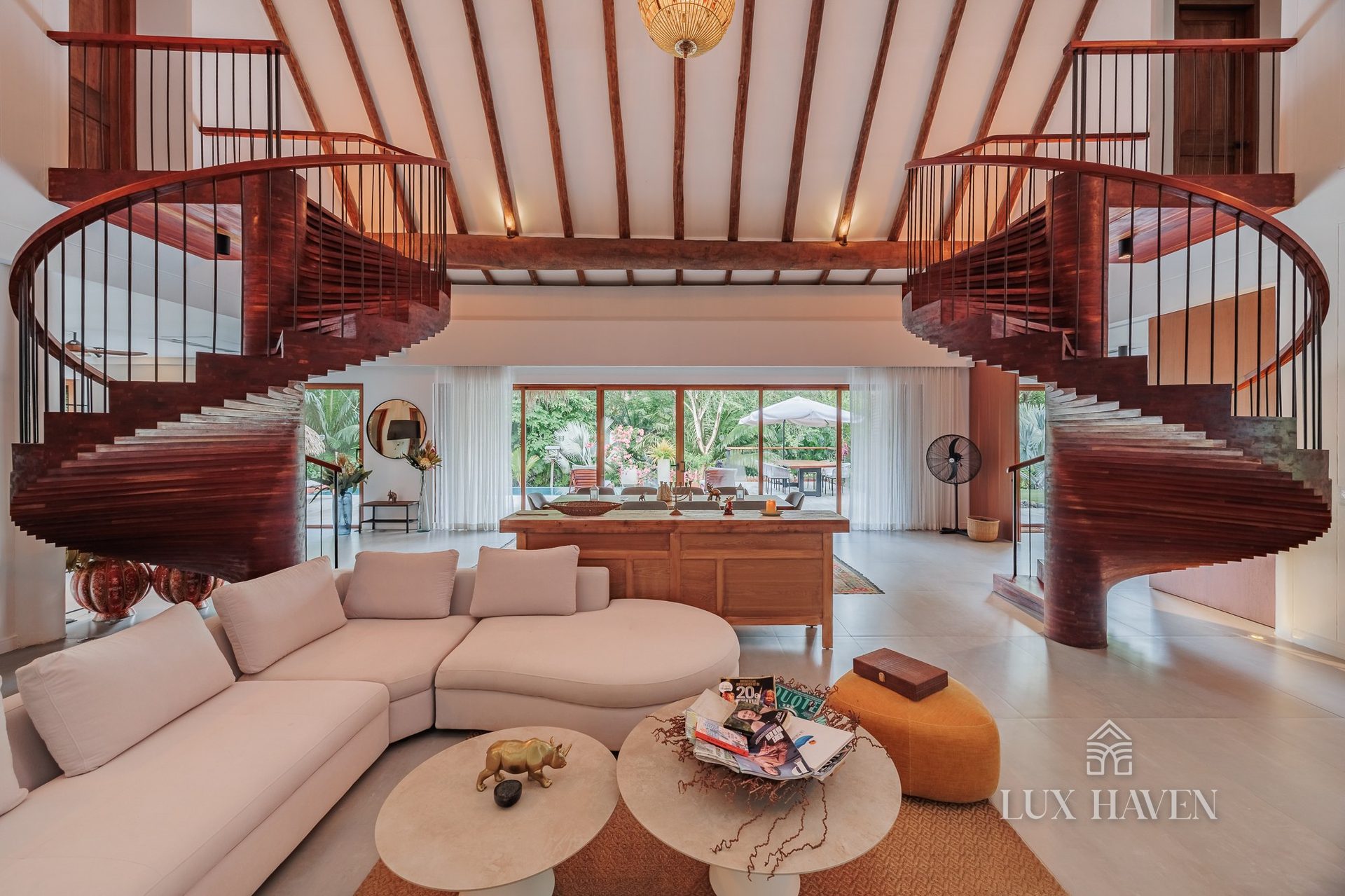 Double-height living hall with twin spiral staircases
