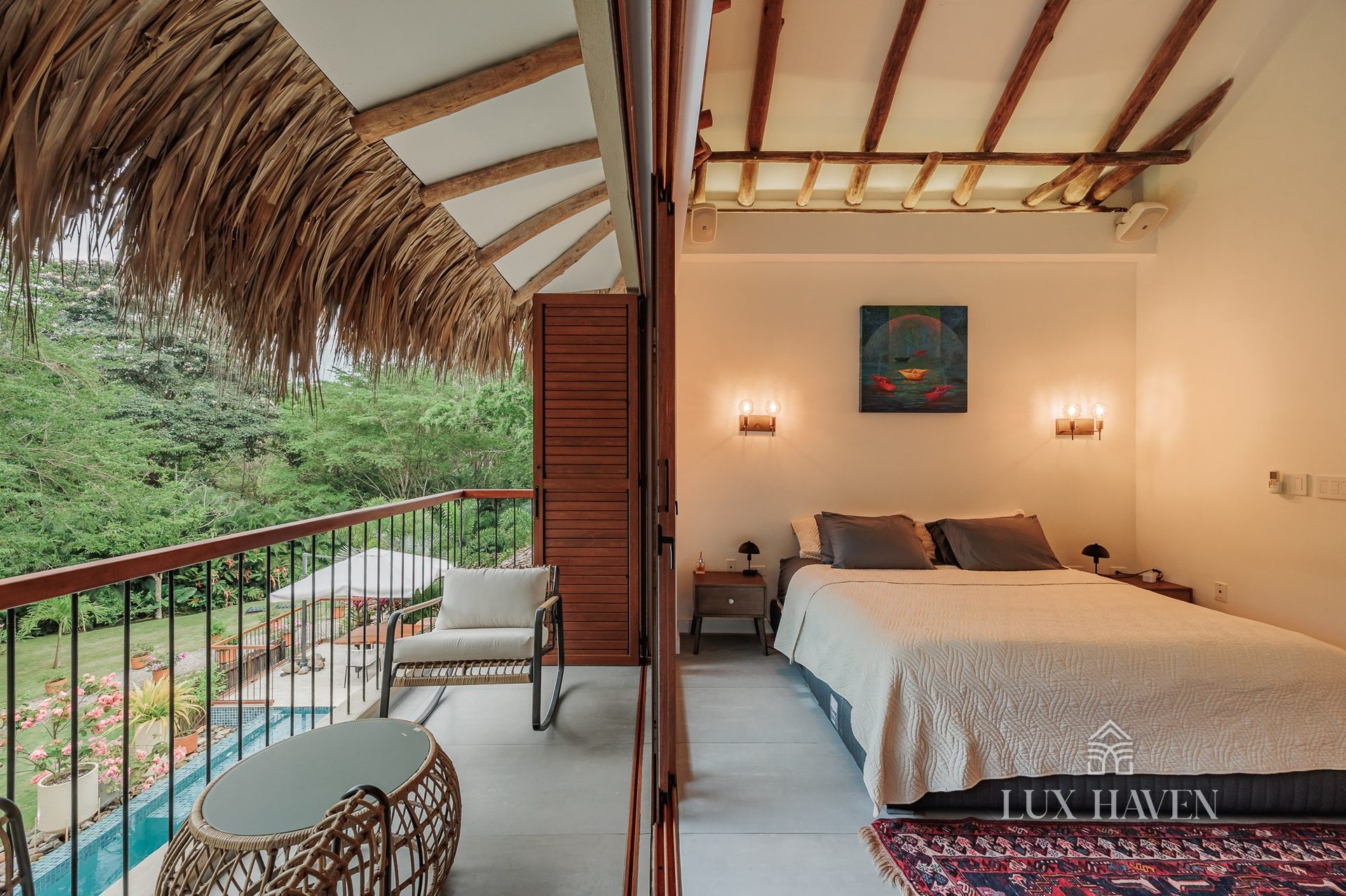 Master suite beneath the palapa roof with private balcony